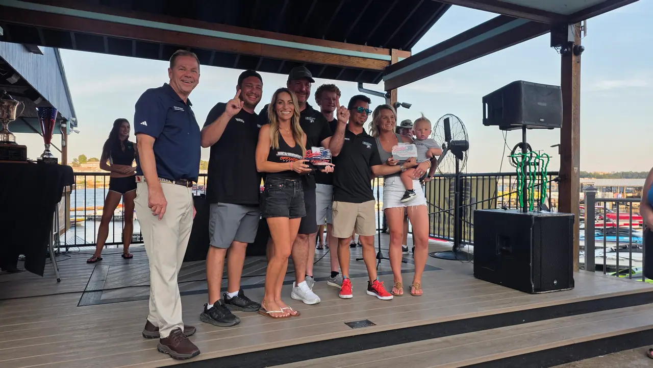 Racers, families and officials gathered on the covered awards stage by the lake