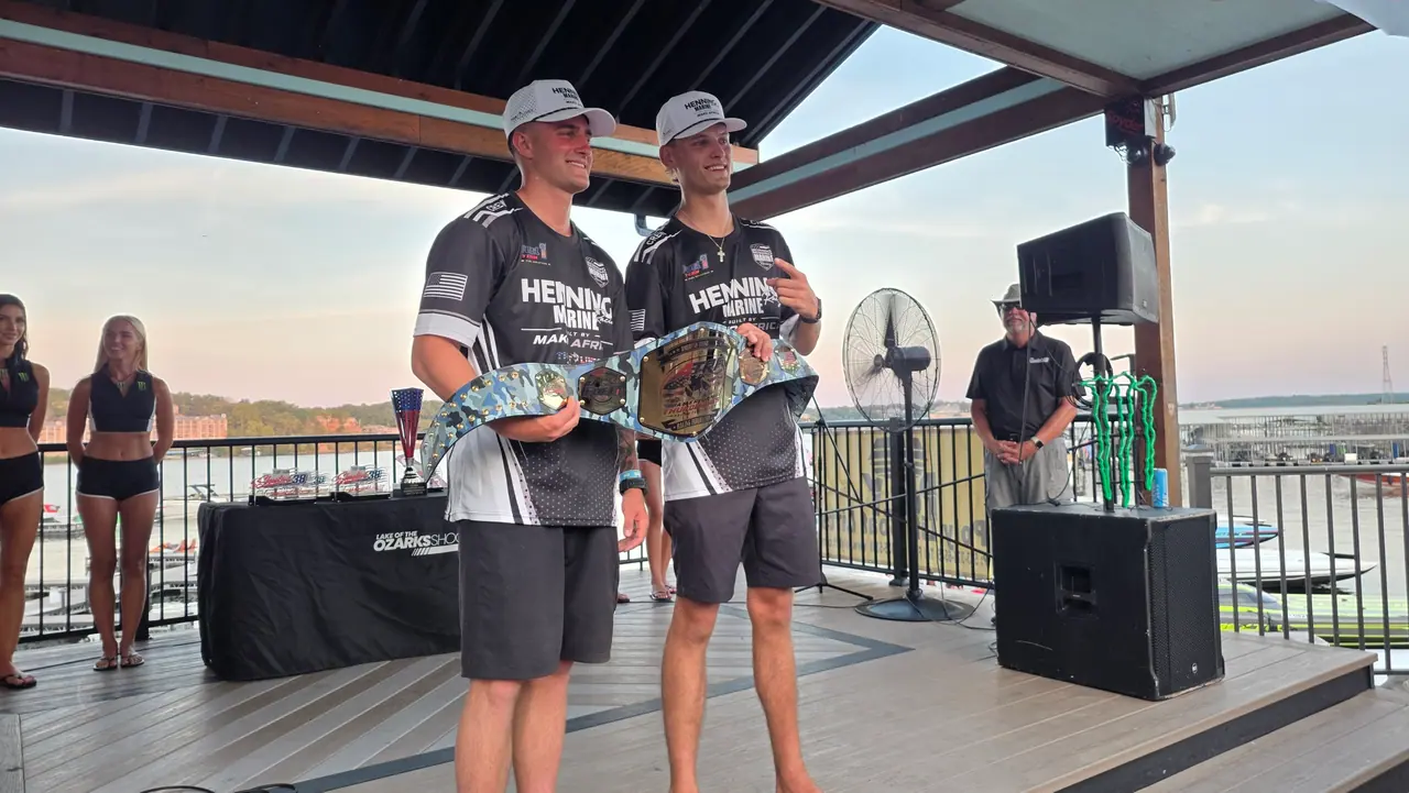 Two Henning Marine ThunderCat racers holding trophies on stage