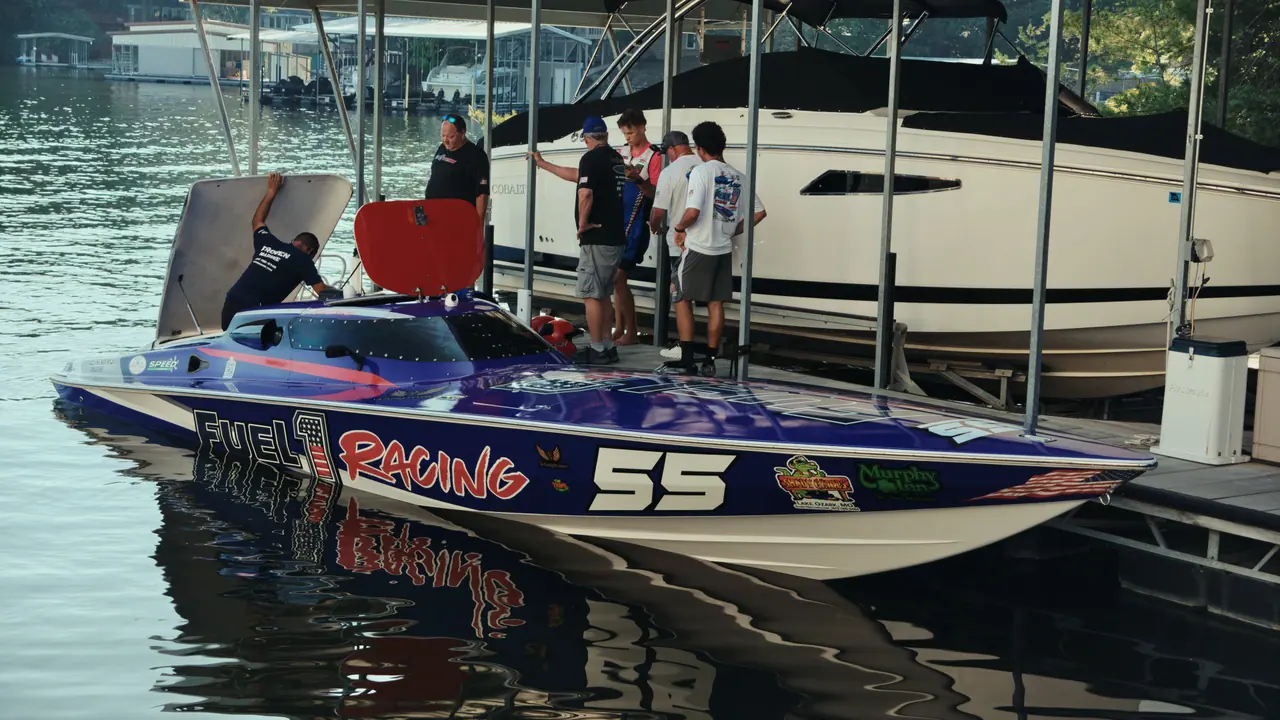 The #55 Phantom tied up at a lakeside boat lift, Fuel 1 branding on the hull