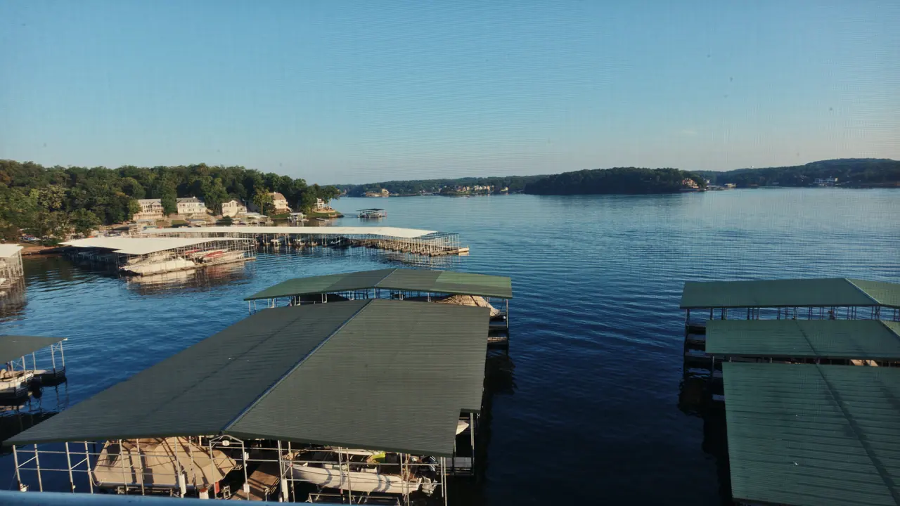 Calm Lake of the Ozarks shoreline with covered docks
