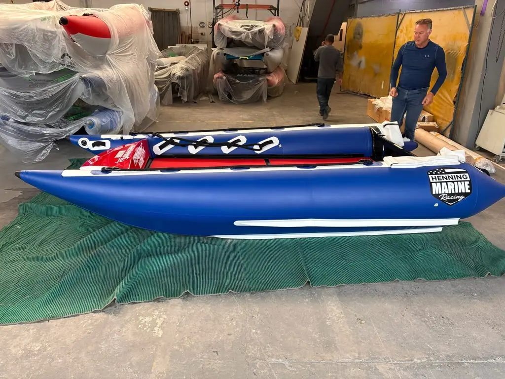The Fuel 1 Team ThunderCat in the build shop: blue sponsons, a red deck and the Henning Marine Racing logo on the side