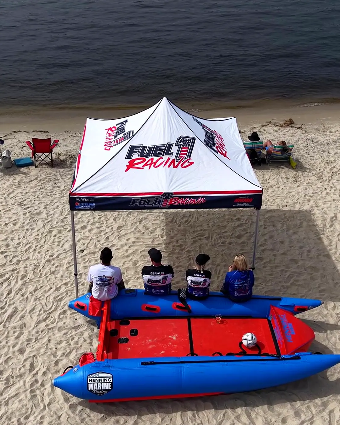 Several inflatable ThunderCat race boats and crews idling together on the water near a bridge